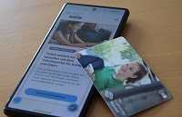 Handy auf dem man das neue Bestellportal siet und das Deutschlandticket Schule als Plastikkarte
